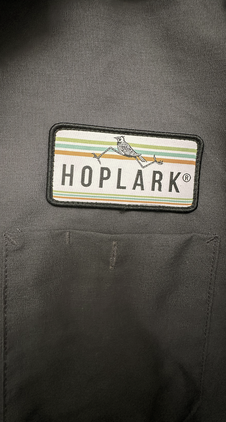 Hoplark logo patch on a dark jacket